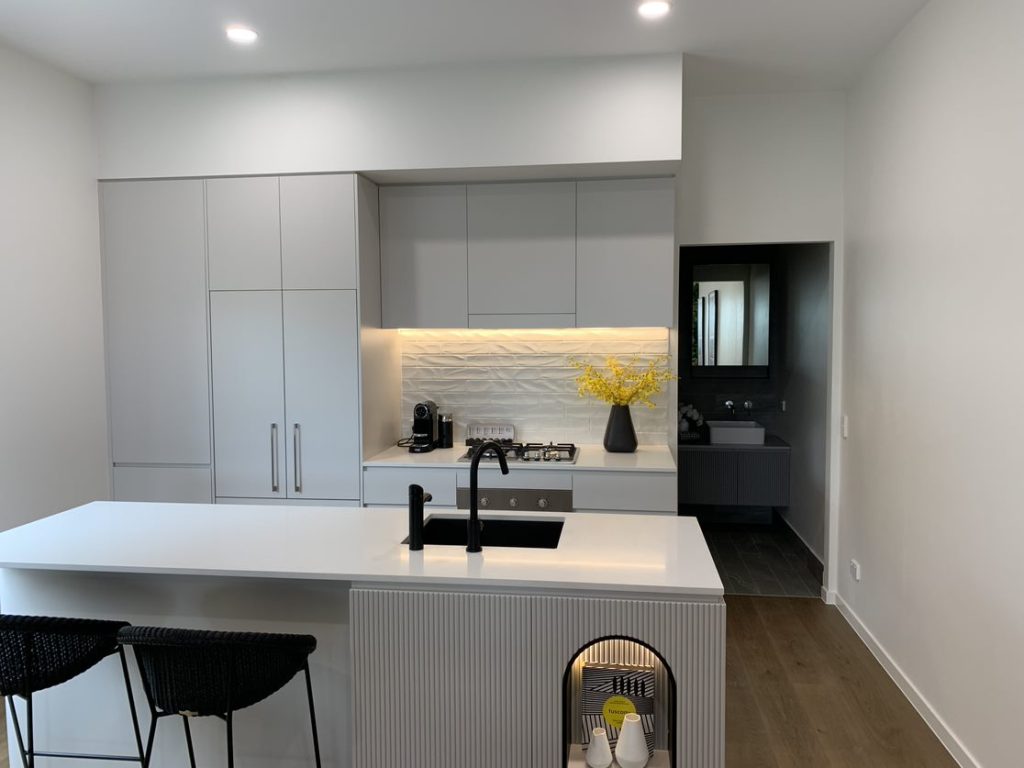 Brickworks Park render of a modern, stylish kitchen with a large, marble, island bench.